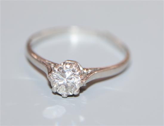 A plat and solitaire diamond ring, (shank split).